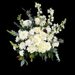 White roses and chrysanthemums arranged with tall white blooms