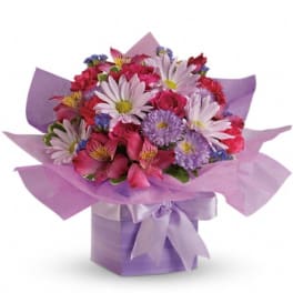 Pink and purple mixed bouquet in a lavender gift box with ribbon