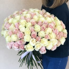 Large bouquet of pale pink and cream roses tied with a ribbon