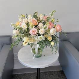 Bouquet of blush and white roses in a glass vase