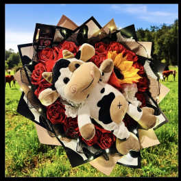 Bouquet of red roses with a plush cow in the center