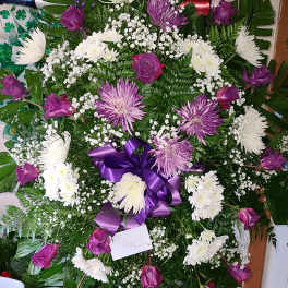 Purple and white funeral wreath with roses and chrysanthemums