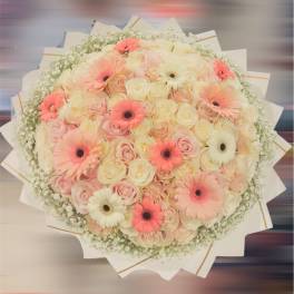 Large bouquet of pink and cream roses with gerbera daisies