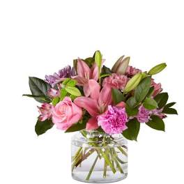 Pink and purple mixed bouquet in a clear glass vase