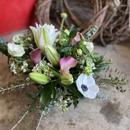 Bouquet of white lilies and pink calla lilies with greenery
