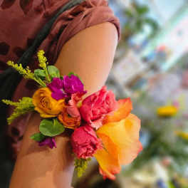 Colorful flower corsage on a person's wrist