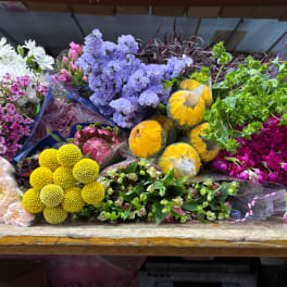 Assorted bouquets of colorful flowers wrapped in plastic