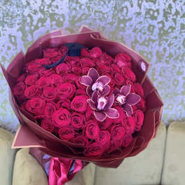 Large bouquet of hot pink roses with a few orchid blooms