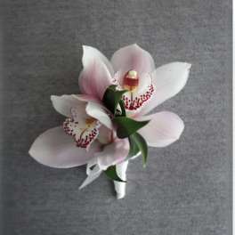 Small bouquet of pink and white orchids with a white ribbon