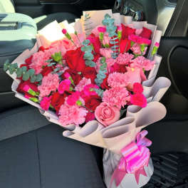 Bouquet of red and pink roses with carnations and eucalyptus