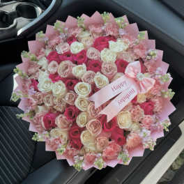 Pink and white rose bouquet with carnations and a birthday ribbon