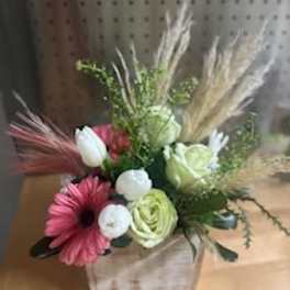 Mixed floral arrangement in a wooden box with pink and white blooms