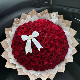 Large bouquet of red roses with a white ribbon bow