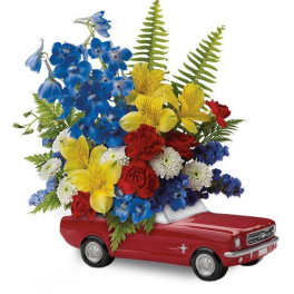 Colorful flower arrangement in a red toy pickup truck