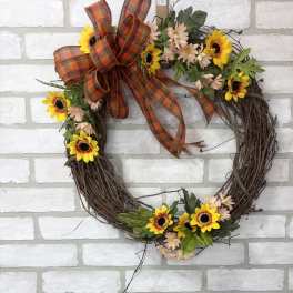 Floral wreath with sunflowers, pale daisies, and a plaid bow
