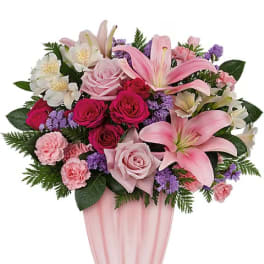 Pink and white mixed flower arrangement in a pink vase