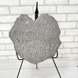 Gray memorial plaque on a black stand with an engraved friendship quote