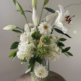 White lilies and hydrangeas in a glittered vase