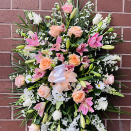 Large pink and white floral standing spray with roses and lilies