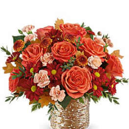 Orange roses and red mums in a woven basket