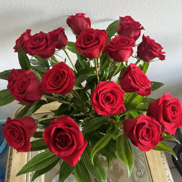 Bouquet of red roses with green foliage