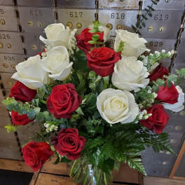 Bouquet of red and white roses in a glass vase