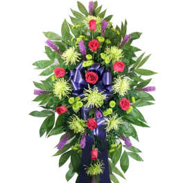 Standing floral spray with red roses, green spider mums, and purple accents