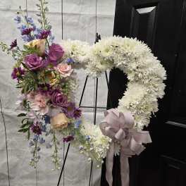 Floral wreath with white chrysanthemums and a pastel rose bouquet on the left