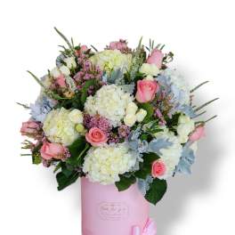 Pink and white rose bouquet in a pink hatbox with a ribbon