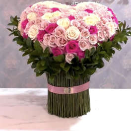 Large bouquet of pink and white roses with a pink ribbon wrap