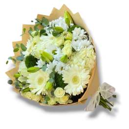 Bouquet of white flowers with pale yellow roses and green buds wrapped in kraft paper