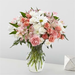 Pink and white mixed bouquet in a clear glass vase