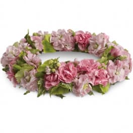 Pink and pale green floral wreath on a white background