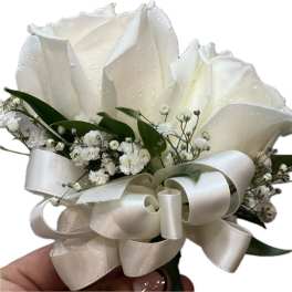 White rose boutonniere with baby's breath and satin ribbon