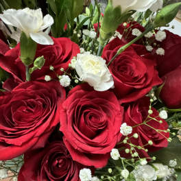 Close-up bouquet of red roses with white filler flowers