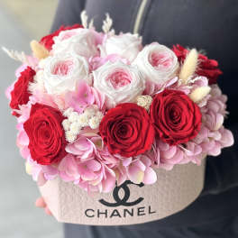 Pink and red roses with hydrangeas in a Chanel box