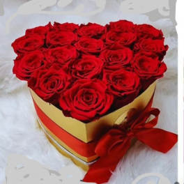 Heart-shaped box of red roses with a red ribbon bow