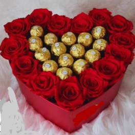 Heart-shaped box of red roses with gold-wrapped chocolates