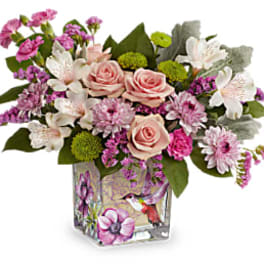 Pink and white mixed bouquet in a decorative glass vase