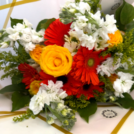 Bouquet of red and yellow flowers with white blooms and greenery