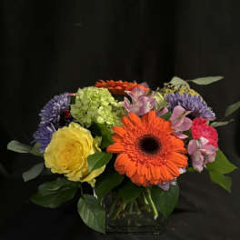 Colorful mixed bouquet in a clear glass vase