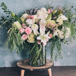 Large pastel bouquet in a glass vase with pink and white flowers