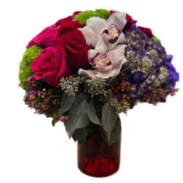 Bouquet of red roses, white orchids, and purple hydrangeas in a red vase