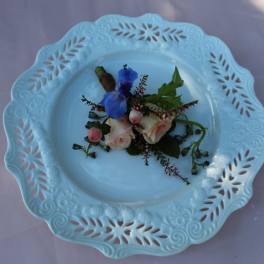 Small floral corsage on a decorative blue plate