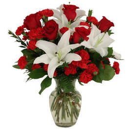 Red roses and white lilies arranged in a glass vase