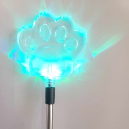 Glowing blue paw-shaped light on a metal pole