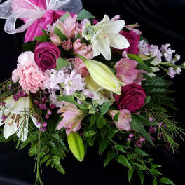 Pink and white mixed bouquet with lilies and roses tied with a ribbon