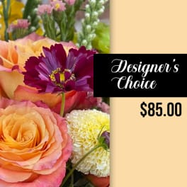Designer’s choice bouquet with peach roses and a purple flower