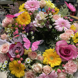 Colorful bouquet of roses, gerbera daisies, and butterflies
