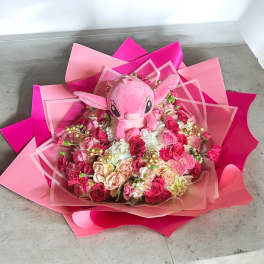 Pink bouquet with a plush character in the center